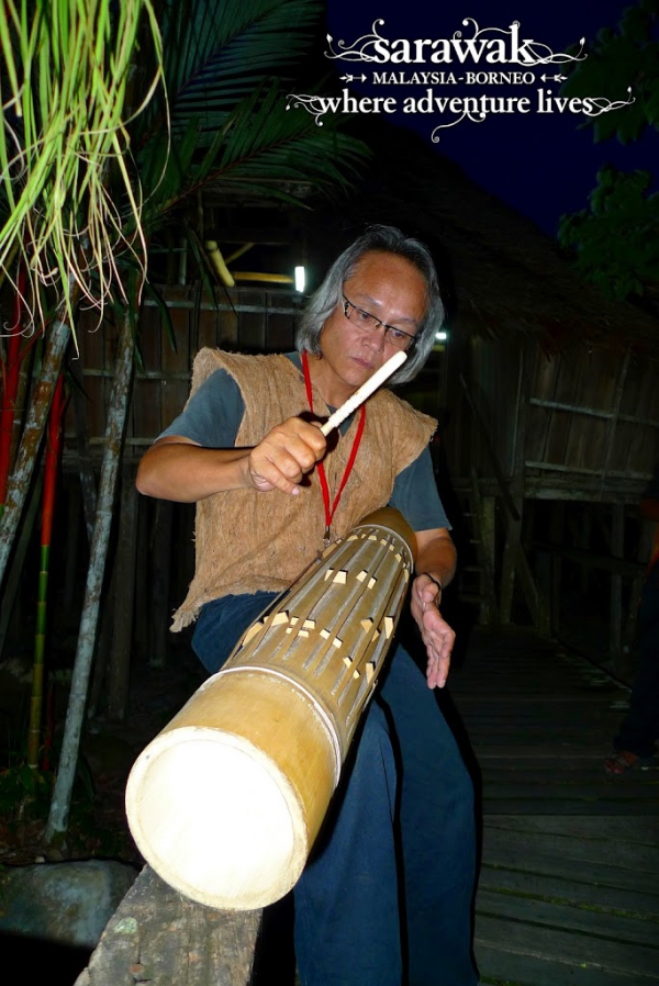 A bidayuh playing his pratuakng, a bamboo percussion musical instrument