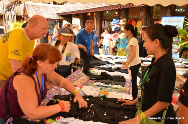 Volunteer tending to customers at the souvenir stall