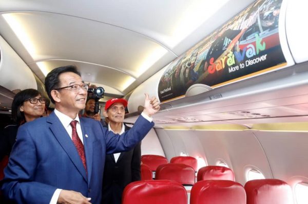 Minister thumb up Sarawak Tourism Board AirAsia cabin ad panel