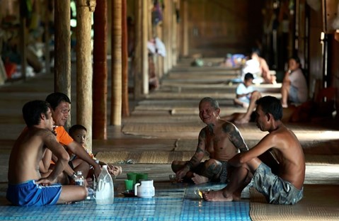 Enjoying local delicacies sitting cross-legged on the rattan mat Image source: Sarawak Travel